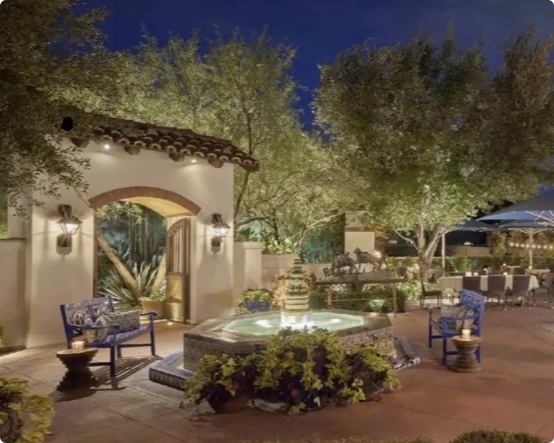 stone patio with furniture and fairy lights